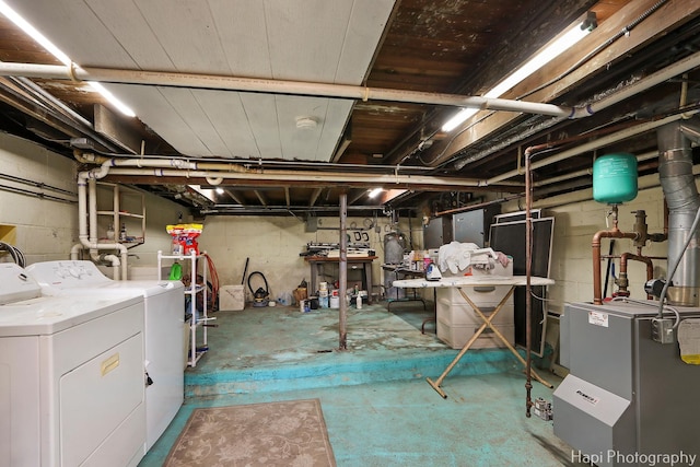 unfinished basement with a heating unit and washer and dryer