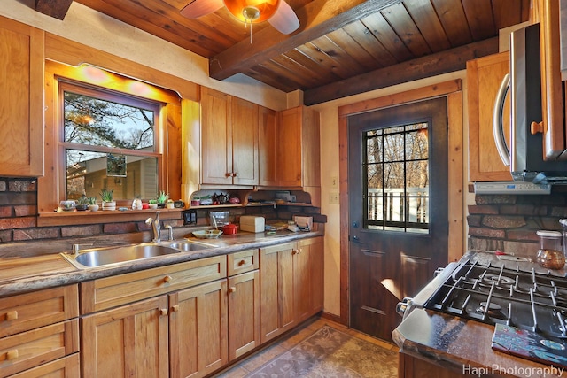 kitchen with wood ceiling, ceiling fan, stainless steel microwave, beamed ceiling, and a sink