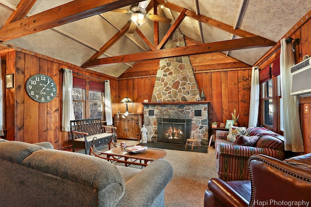 carpeted living room featuring ceiling fan, high vaulted ceiling, wooden walls, a fireplace, and beam ceiling