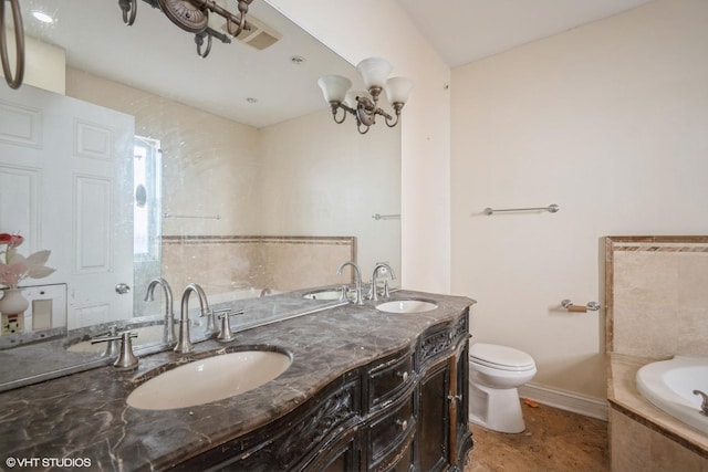 bathroom featuring tiled bath, double vanity, toilet, and a sink