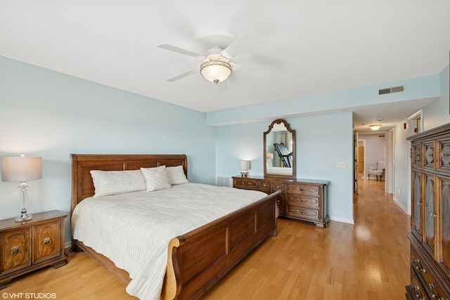 bedroom featuring visible vents, baseboards, light wood-style floors, and a ceiling fan