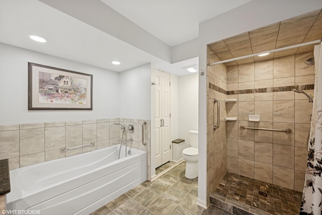 bathroom with a bath, recessed lighting, a shower stall, and toilet