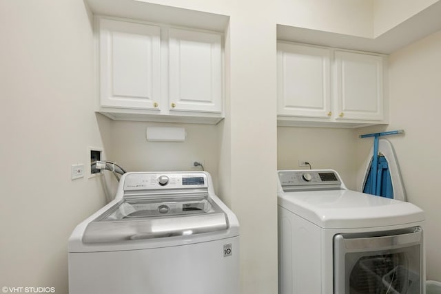 laundry area featuring cabinet space and washing machine and clothes dryer