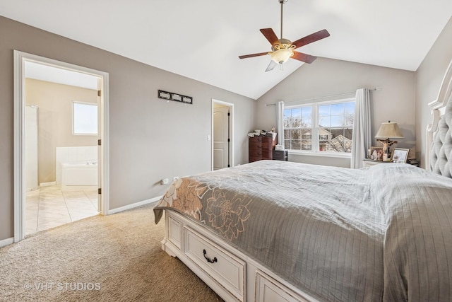 bedroom with lofted ceiling, light colored carpet, baseboards, and multiple windows