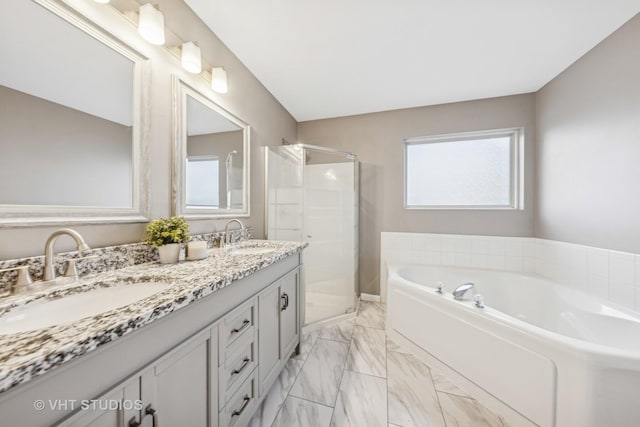 bathroom with a stall shower, plenty of natural light, and a sink