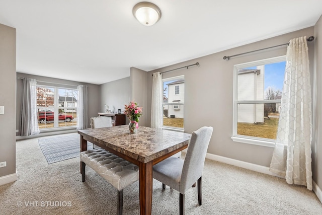 dining area featuring carpet floors and baseboards