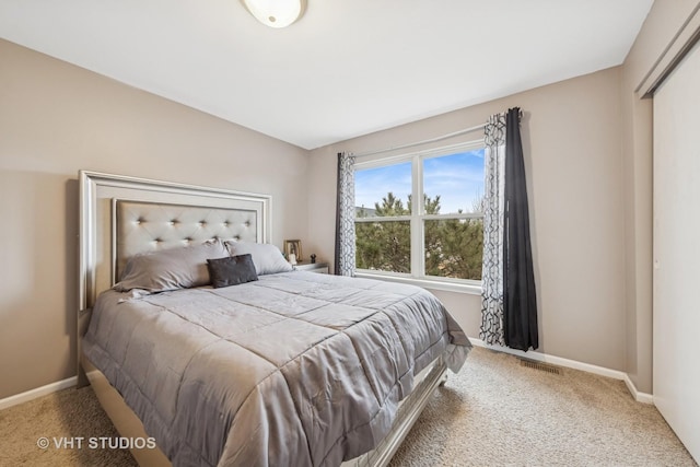 bedroom with carpet floors, visible vents, and baseboards