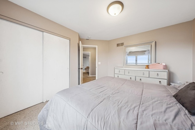 bedroom with speckled floor, a closet, and visible vents