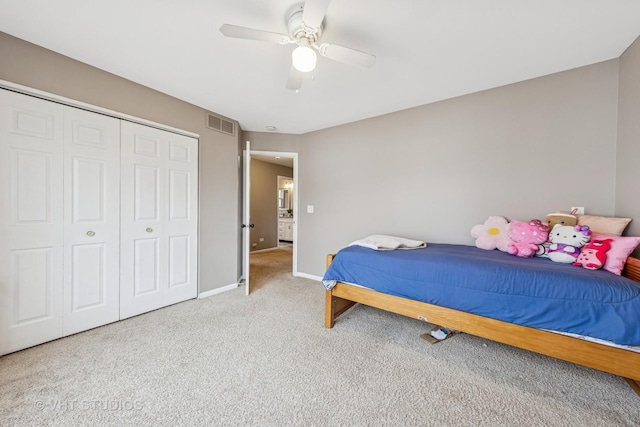 carpeted bedroom with ceiling fan, a closet, visible vents, and baseboards