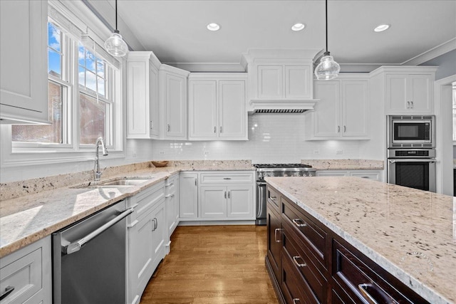 kitchen with a sink, stainless steel appliances, and white cabinetry