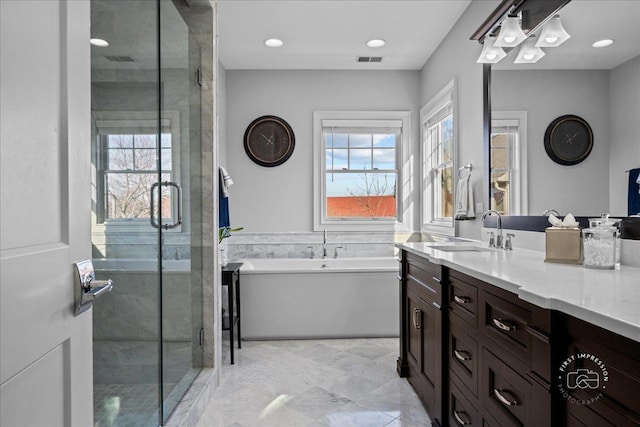 bathroom featuring visible vents, a stall shower, recessed lighting, a bath, and vanity