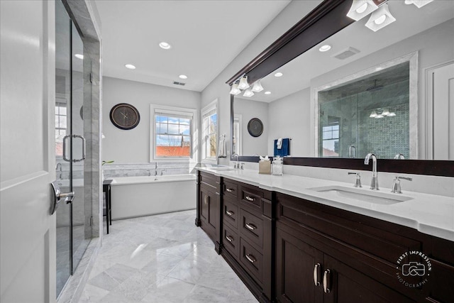 full bathroom with visible vents, a soaking tub, double vanity, a sink, and a shower stall