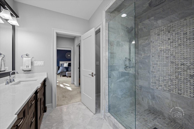 bathroom featuring a tile shower, vanity, and ensuite bathroom