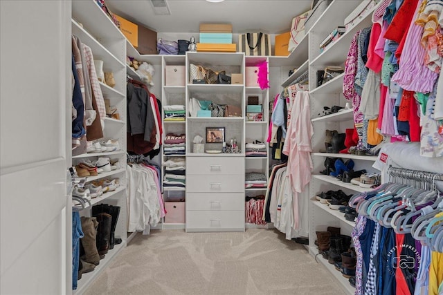 walk in closet with carpet floors