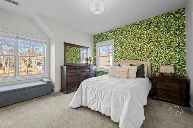 carpeted bedroom with visible vents, baseboards, and wallpapered walls