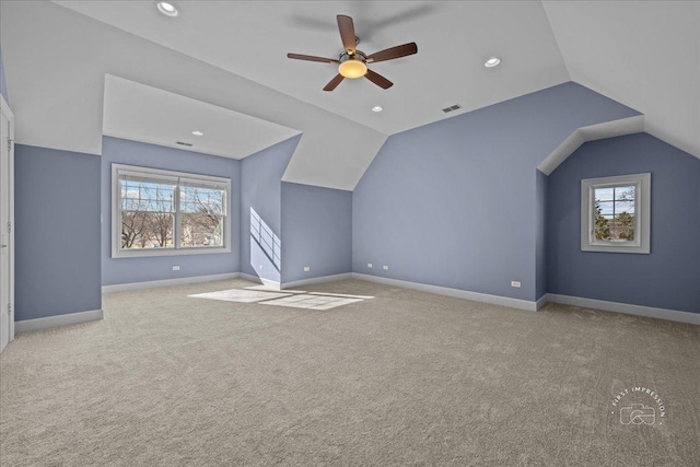 additional living space with visible vents, carpet, and a healthy amount of sunlight