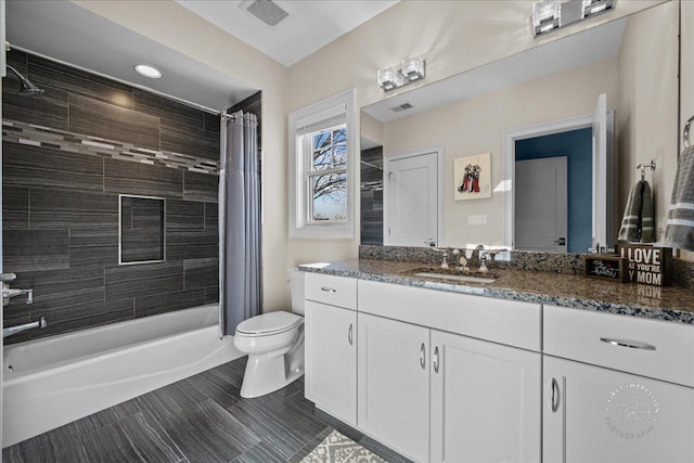 bathroom with visible vents, toilet, vanity, and shower / bath combination with curtain