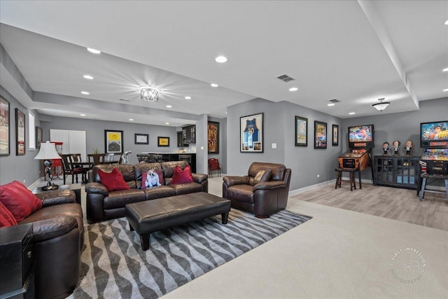 living room with recessed lighting, visible vents, baseboards, and a bar