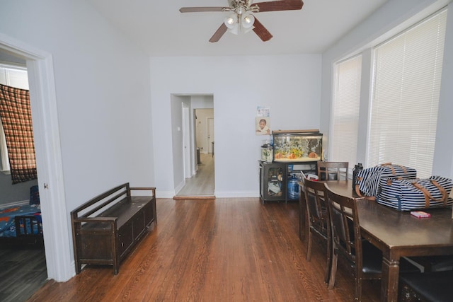 dining room featuring wood finished floors, a ceiling fan, and baseboards