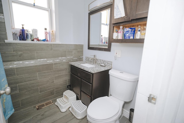 bathroom featuring visible vents, plenty of natural light, and toilet