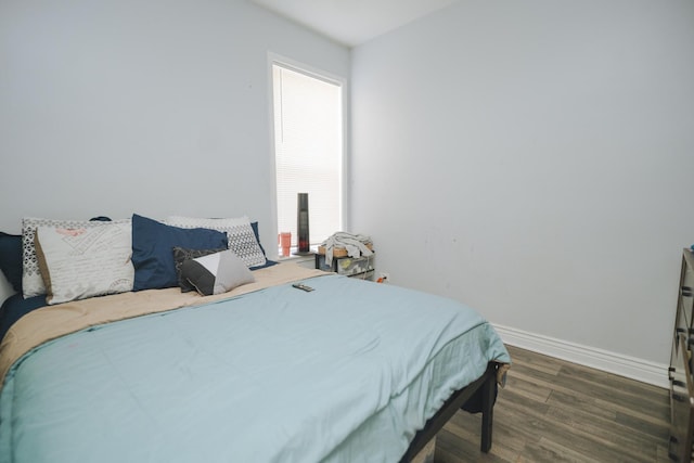 bedroom with wood finished floors and baseboards