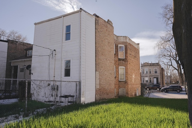 view of property exterior featuring a yard and fence