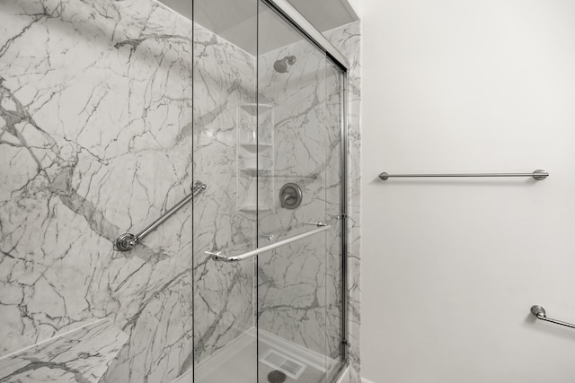 full bath featuring a marble finish shower