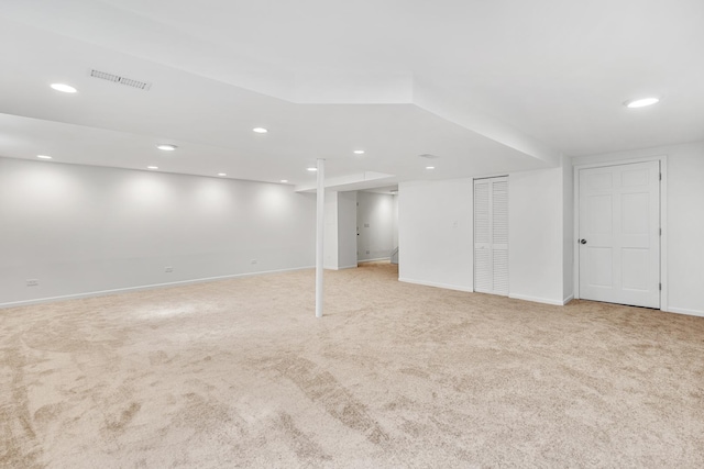 finished basement with recessed lighting, visible vents, and light carpet