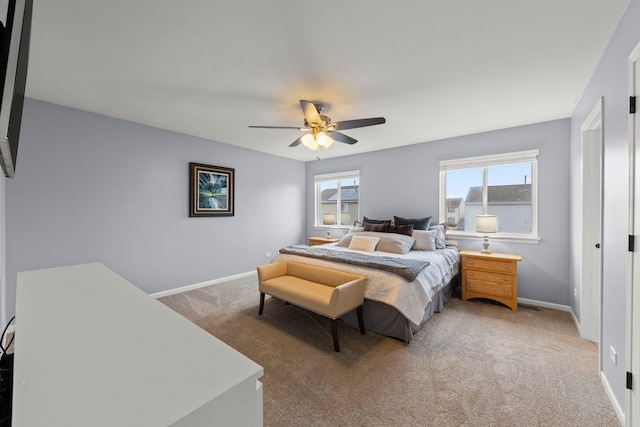 bedroom featuring light carpet, ceiling fan, and baseboards