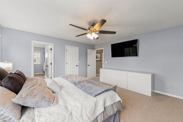 bedroom featuring light carpet, baseboards, and a ceiling fan