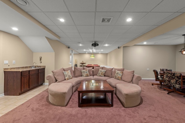 living room with light carpet, wet bar, visible vents, and light tile patterned flooring