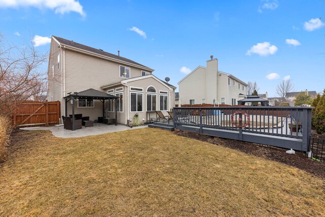 back of house with a gazebo, a yard, a fenced backyard, and a wooden deck