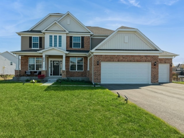 craftsman-style home with a garage, brick siding, driveway, and a front lawn