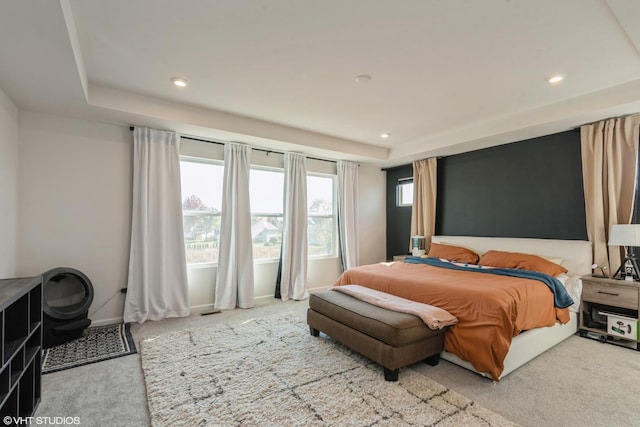 bedroom featuring baseboards, a tray ceiling, carpet flooring, and recessed lighting