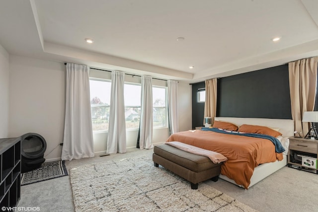 bedroom with baseboards, carpet floors, a tray ceiling, and recessed lighting