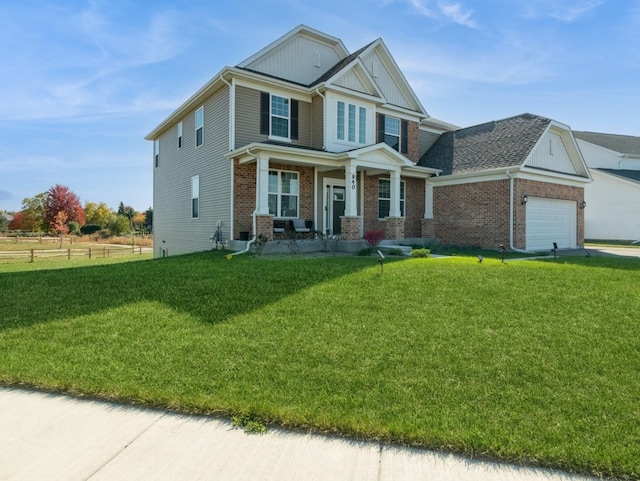 craftsman-style home featuring fence, a porch, brick siding, a front yard, and a garage