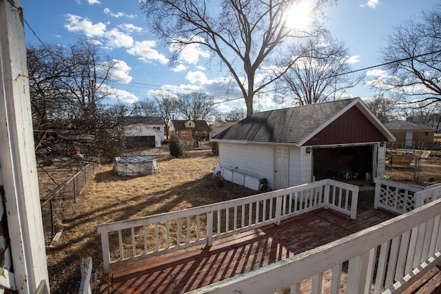 exterior space with a detached garage, fence, and an outdoor structure