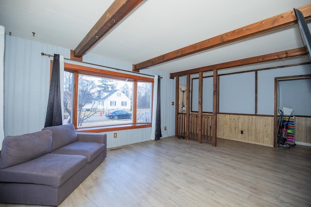 living room with beam ceiling and wood finished floors