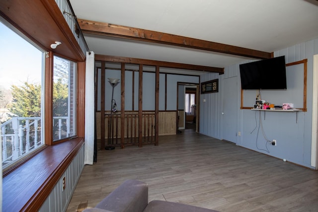 interior space featuring light wood-style floors and beamed ceiling