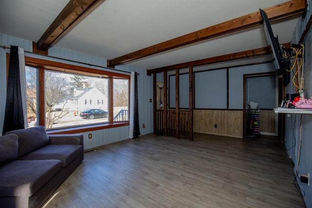 interior space featuring wood finished floors and beam ceiling