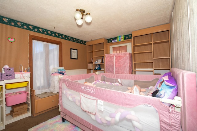 bedroom with carpet and a textured ceiling