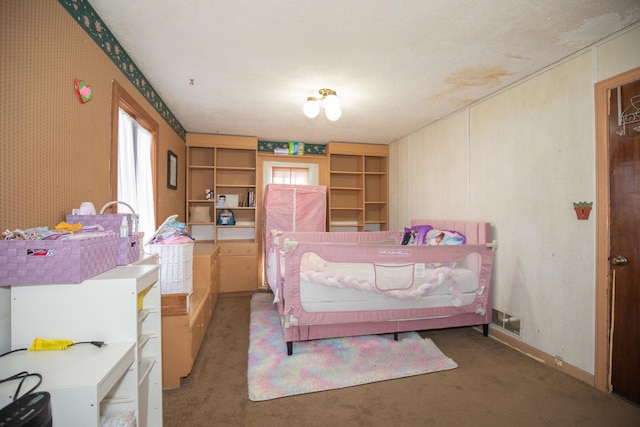 carpeted bedroom featuring wallpapered walls and visible vents