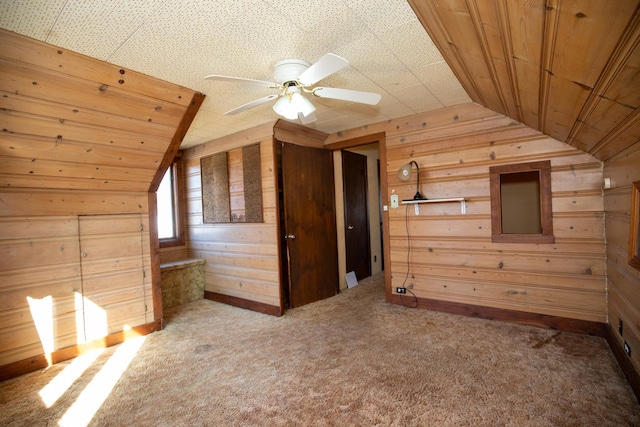 bonus room featuring vaulted ceiling, wood walls, carpet, and wood ceiling