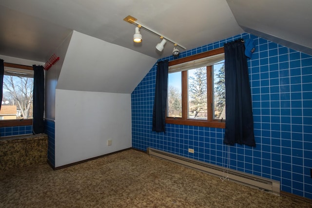 bonus room featuring lofted ceiling, baseboards, baseboard heating, and carpet flooring