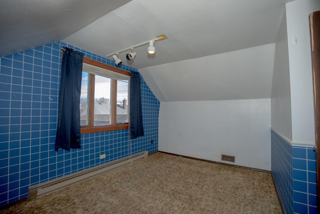 bonus room with a baseboard heating unit, carpet, lofted ceiling, and visible vents