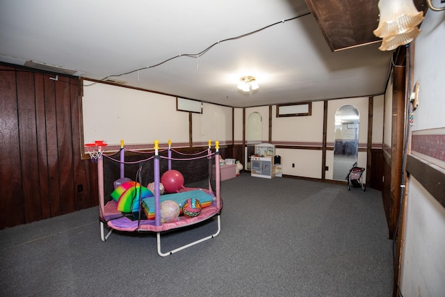 playroom with carpet floors and arched walkways