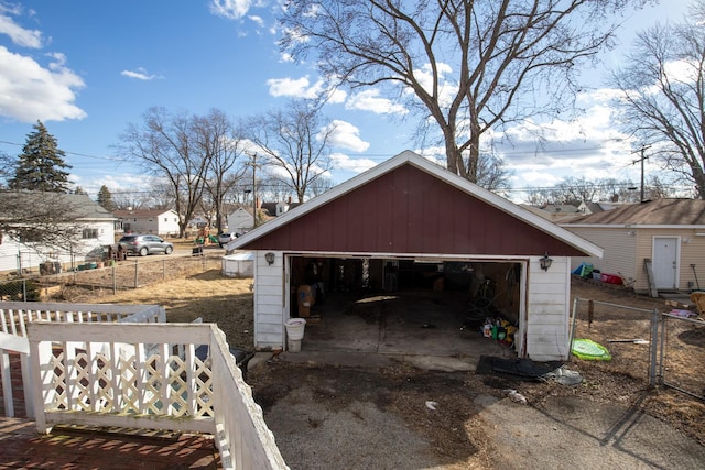 detached garage featuring fence