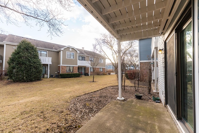 view of yard featuring a patio area and a residential view