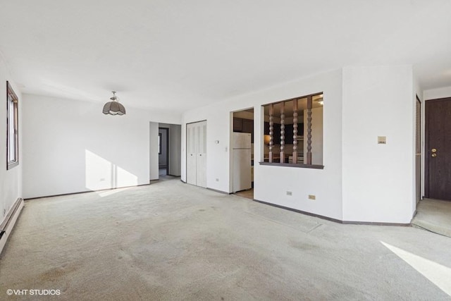 empty room with light carpet and baseboards