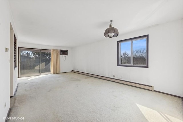 unfurnished room with a wealth of natural light, a baseboard radiator, an AC wall unit, and carpet